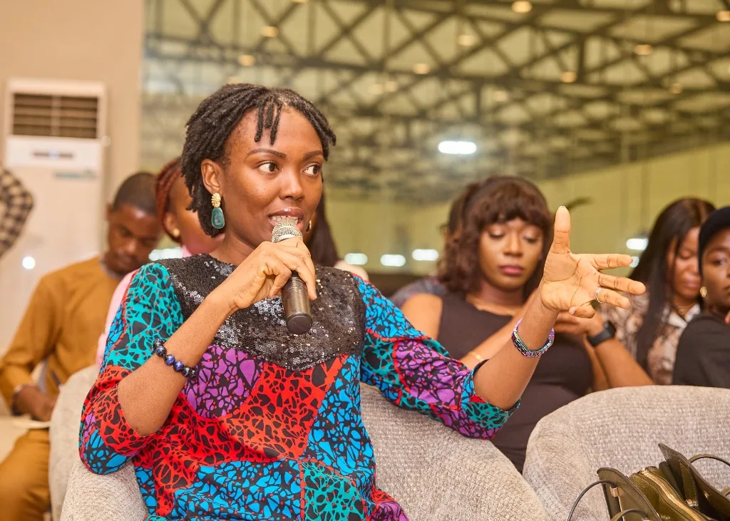 A member speaking into a microphone at an IDAN session