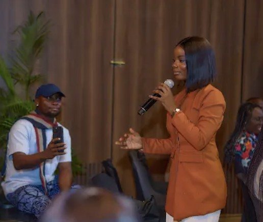 An audience member speaking at AIDC 2025